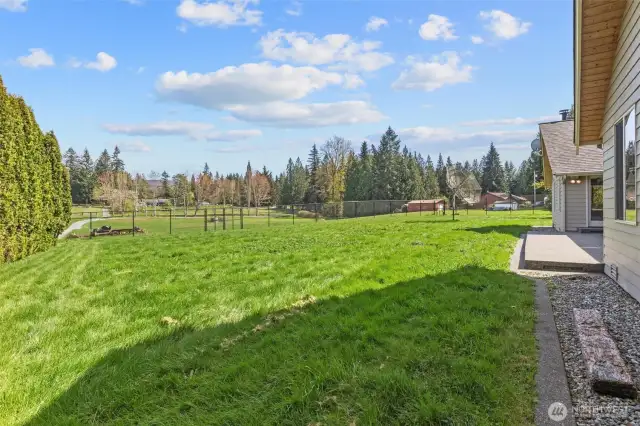 Fully fenced yard! Property extends to tree line/gravel driveway.