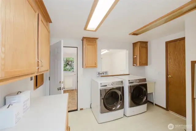 Conveniently located off the mud room, with access to both the kitchen and the main bath, the generous-sized laundry room offers plenty of functionality. It features a laundry sink, plenty of ample cabinets and counter space. The washer and dryer stay, making it ready for immediate use. A powder room off the laundry adds extra convenience, perfect for guests or busy days.