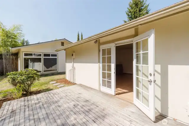This charming second studio offers a compact yet functional space, featuring a small kitchen, bath, and room for both a bed and a cozy table. Two sets of French doors open up to the outdoors, allowing for natural light to fill the space. The studio enjoys a wrap-around deck on two sides, providing the perfect vantage point to take in the tranquil view of the pond—a peaceful retreat for guests or a quiet escape.