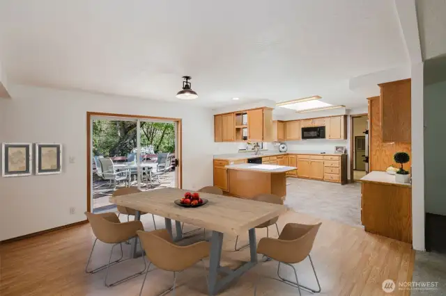 Designed for easy entertaining and seamless indoor-outdoor living, the dining area features a built-in buffet (not shown in the picture) and patio doors that lead to a spacious deck—ideal for gatherings or quiet mornings. The open layout flows into the kitchen with a breakfast bar, allowing the cook to stay part of the conversation while guests relax in the great room, dining area, or out on the deck. Virtually staged.