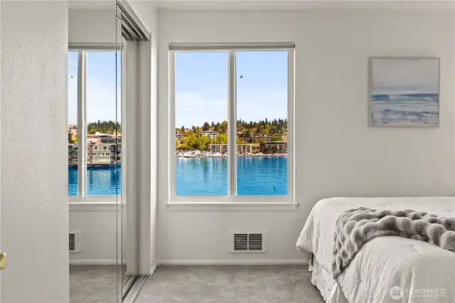 Primary bedroom features a view to the Kirkland marina and lake, and a full ensuite bathroom.