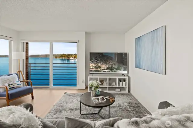 Enjoy the floor to ceiling windows and views over the lake and Olympic mountains from the living room!