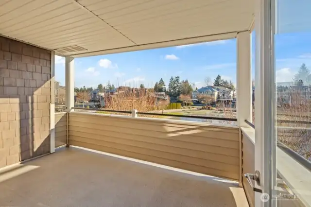 Oversized covered deck with water feature view.