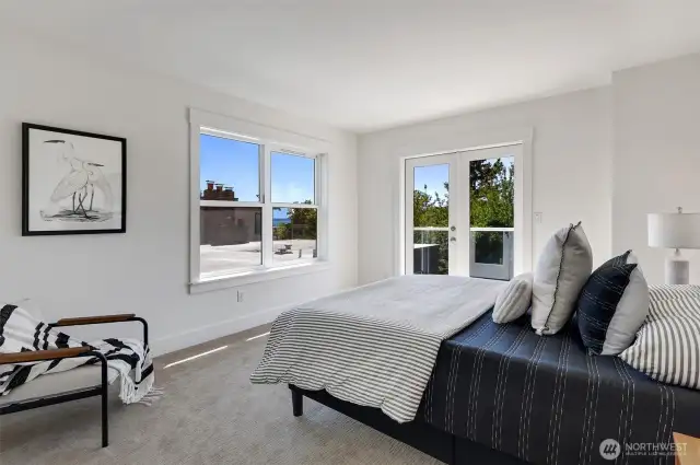 Upper primary bedroom with its own balcony and sunset views.