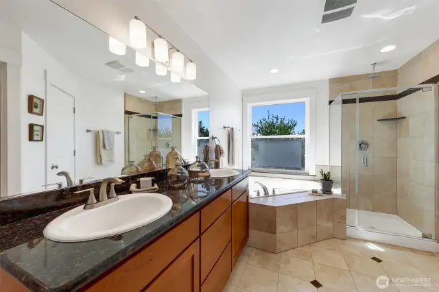 Luxurious primary bathroom with two sinks, private water closet, soaking tub and beautiful views.