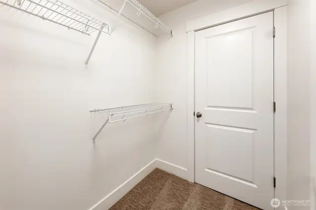 Primary walk-in closet. Behind the door is the furnace, installed in 2018.