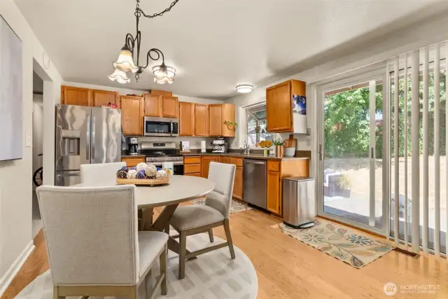 Open dining area flows effortlessly into the kitchen and backyard.