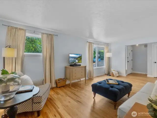 Natural light pours in through oversized windows, highlighting the craftsmanship and character throughout.