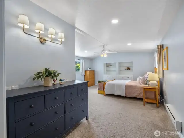 Tucked upstairs for privacy, the serene primary suite is a true retreat.