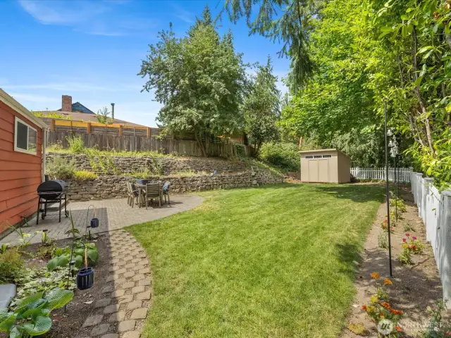Fully fenced and lined with lush, vibrant green grass, this generous yard offers both beauty and function.