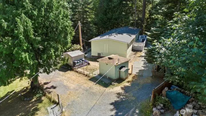 Drone view of home and well pump house