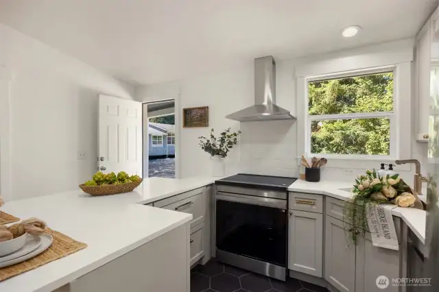 In this stylish kitchen remodel you will find all new appliances to include induction cook top with a convection oven, hood vent, dishwasher, fridge, and microwave.
