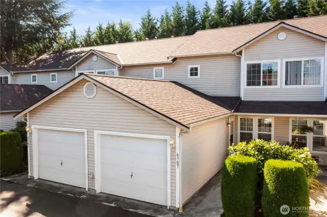 This fabulous unit is in the back of the complex. Note the mature landscaping and attached 1-car garage.