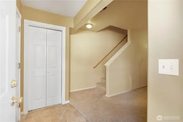This is your view as you walk in the front door. The coat closet is straight ahead with garage access to the left and stairs to the upstairs in view.