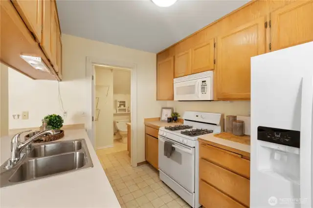 This kitchen flooring has actually been replaced with more modern floors - go see the unit in person to see how lovely they turned out! PS: Cooking with gas is the best!