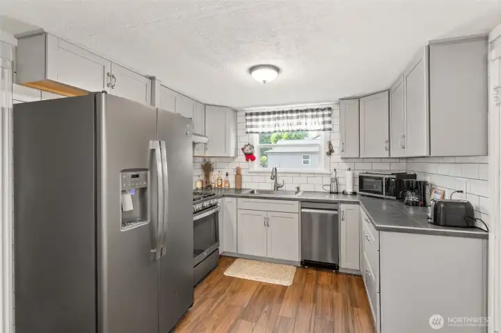 Brand new kitchen with stainless steel appliances.