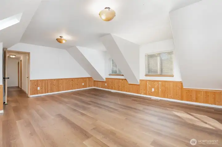 Upstairs bonus room with vaulted ceilings.