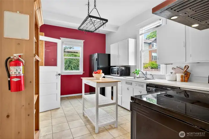 Kitchen entry from dining room, featuring natural light and direct access to the laundry room.
