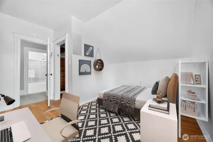 Upstairs bedroom with natural light, walk-in closet, and easy access to the full bathroom. (Virtually Staged.)