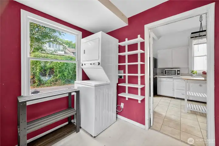 Main floor laundry room with access to the side yard and staircase to the basement, offering practical functionality.