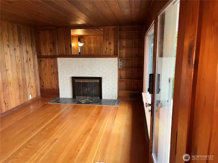 The charming living room features a fireplace the gather around to share stories of your days adventures exploring the beach or playing yard games. The charming living room features a fireplace the gather around to share stories of your days adventures exploring the beach or playing yard games.