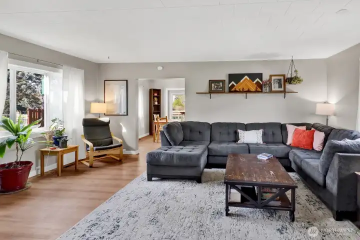 A warm and inviting living area that keeps the farmhouse charm vibe thriving, offering a cozy and comfortable space to relax and gather.