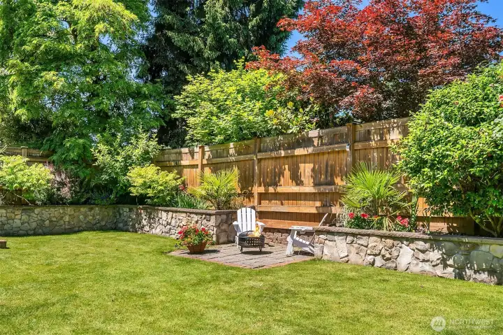 Something new is always blooming in this gorgeous, private, low maintenance yard.