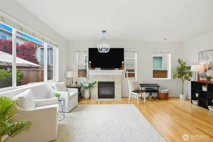 Open Living Area Sun-filled living room with expansive windows, contemporary lighting, hardwood flooring, and a seamless open layout that enhances the home's airy feel. Open Living Area Sun-filled living room with expansive windows, contemporary lighting, hardwood flooring, and a seamless open layout that enhances the home's airy feel.
