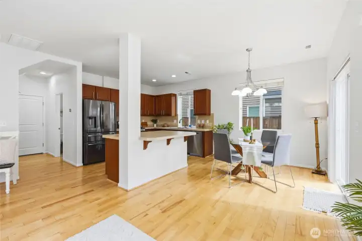 Kitchen & Dining Area Bright, open-concept kitchen and dining space featuring hardwood floors, abundant natural light, and a seamless layout ideal for everyday living and entertaining. Kitchen & Dining Area Bright, open-concept kitchen and dining space featuring hardwood floors, abundant natural light, and a seamless layout ideal for everyday living and entertaining.