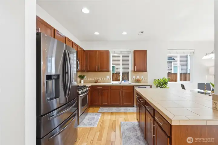 Kitchen with Island Spacious kitchen with rich wood cabinetry, stainless steel appliances, ample counter space, and a large center island offering additional storage and workspace. Kitchen with Island Spacious kitchen with rich wood cabinetry, stainless steel appliances, ample counter space, and a large center island offering additional storage and workspace.