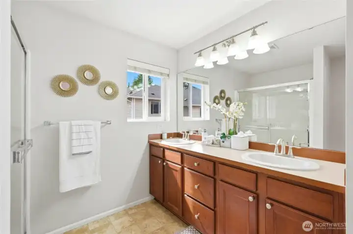 Primary Bathroom Well-appointed primary bathroom with dual-sink vanity, generous counter space, large mirror, shower with sliding glass doors, and a bright, functional layout designed for everyday ease. Primary Bathroom Well-appointed primary bathroom with dual-sink vanity, generous counter space, large mirror, shower with sliding glass doors, and a bright, functional layout designed for everyday ease.
