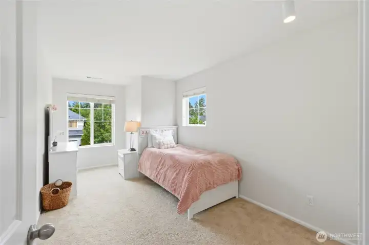 Bedroom Bright and comfortable secondary bedroom featuring plush carpeting, large windows, and ample space for guests, children, or a home office. Bedroom Bright and comfortable secondary bedroom featuring plush carpeting, large windows, and ample space for guests, children, or a home office.