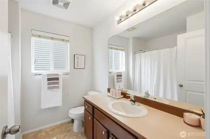 Full Bathroom Bright and functional full bathroom featuring a large vanity, ample counter space, oversized mirror, and a window that brings in natural light. Full Bathroom Bright and functional full bathroom featuring a large vanity, ample counter space, oversized mirror, and a window that brings in natural light.