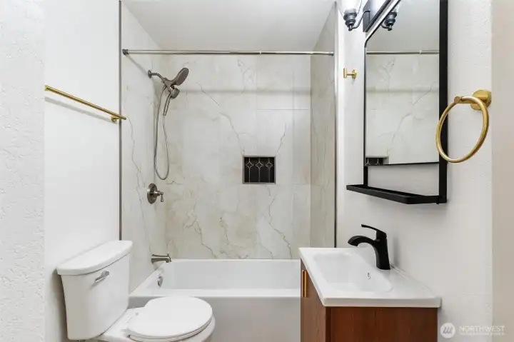 New plumbing and fixtures throughout. Luxury tile surround.
