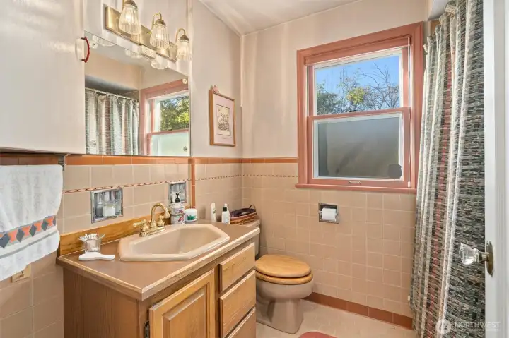 Main floor full bath with the original tile, character and feel of a bye gone era!