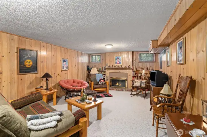 The lower family room has so much character and you can have those chilly Seattle nights in front of your wood burning fireplace.