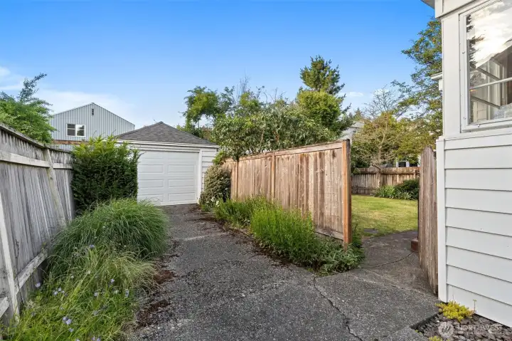 Detached one car garage with ample storage space and loads of off street parking in the driveway.