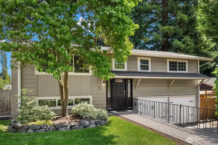 A second exterior view highlights the home's beautiful mature trees and manicured landscaping, with a charming front walkway leading to the covered entry. A second exterior view highlights the home's beautiful mature trees and manicured landscaping, with a charming front walkway leading to the covered entry.