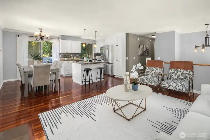This view from the living room draws the eye through to the dining area and chef-style kitchen, showcasing the home's excellent flow and open, light-filled layout. This view from the living room draws the eye through to the dining area and chef-style kitchen, showcasing the home's excellent flow and open, light-filled layout.