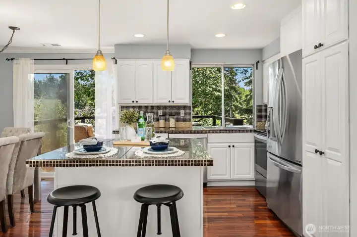 This angle highlights the kitchen's bright window overlooking the backyard, crisp white cabinetry, and island storage, creating a functional and inviting space for the home chef. This angle highlights the kitchen's bright window overlooking the backyard, crisp white cabinetry, and island storage, creating a functional and inviting space for the home chef.