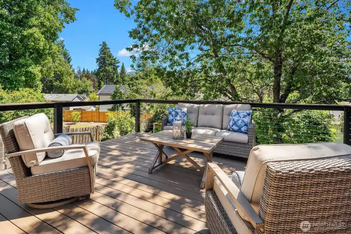The expansive entertainer's deck offers a generous seating area surrounded by lush mature trees, providing a private and tranquil outdoor retreat perfect for relaxing or hosting guests. The expansive entertainer's deck offers a generous seating area surrounded by lush mature trees, providing a private and tranquil outdoor retreat perfect for relaxing or hosting guests.