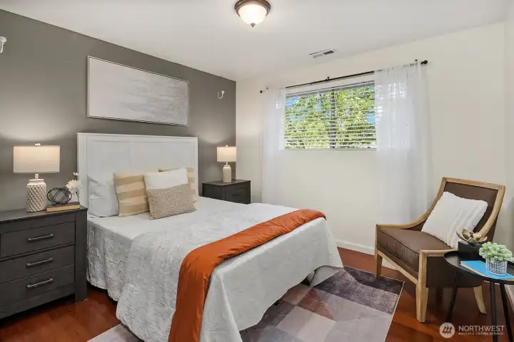 One of three upstairs bedrooms offers a comfortable and cozy retreat with hardwood floors, a bright window, and ample space for furniture and storage. One of three upstairs bedrooms offers a comfortable and cozy retreat with hardwood floors, a bright window, and ample space for furniture and storage.