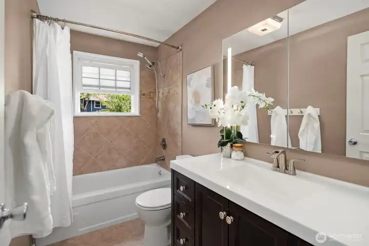 The full bathroom features a classic vanity with ample counter space, a shower-tub combo, and elegant finishes, offering a clean and functional space for the whole family. The full bathroom features a classic vanity with ample counter space, a shower-tub combo, and elegant finishes, offering a clean and functional space for the whole family.