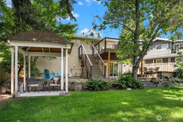 The charming backyard gazebo provides a shaded retreat for outdoor dining or relaxing, complementing the expansive lawn and creating yet another inviting entertaining zone in this beautifully landscaped yard. The charming backyard gazebo provides a shaded retreat for outdoor dining or relaxing, complementing the expansive lawn and creating yet another inviting entertaining zone in this beautifully landscaped yard.