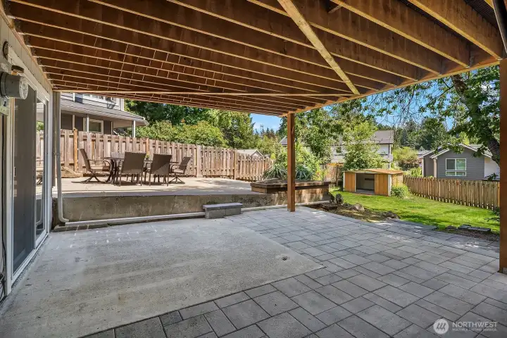 The large covered patio beneath the deck provides a spacious all-weather outdoor living area, extending the home's entertaining space and offering a seamless transition to the backyard beyond. The large covered patio beneath the deck provides a spacious all-weather outdoor living area, extending the home's entertaining space and offering a seamless transition to the backyard beyond.