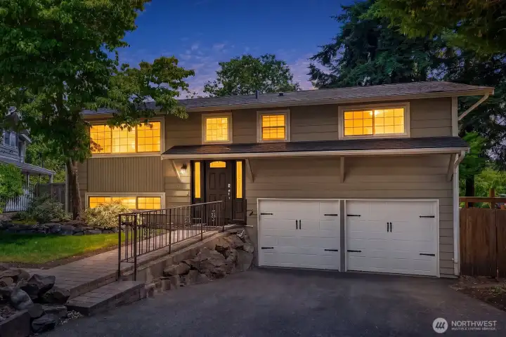 The exterior of this charming Hazen Hills home showcases classic curb appeal with a welcoming covered entry, 2-car garage, and lush mature landscaping bathed in warm evening light. The exterior of this charming Hazen Hills home showcases classic curb appeal with a welcoming covered entry, 2-car garage, and lush mature landscaping bathed in warm evening light.