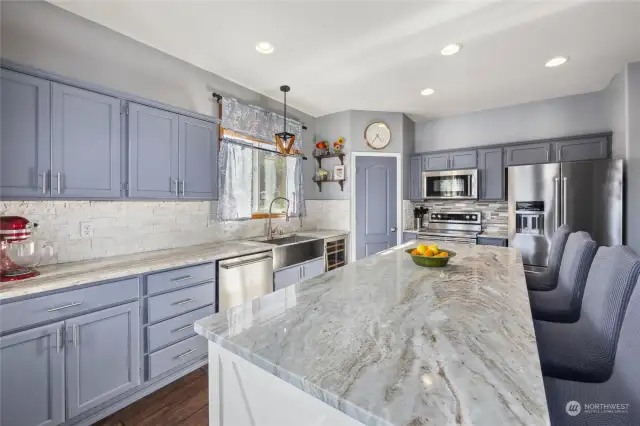 Beautiful kitchen with granite counters, rock back splash, and fresh paint. Plus plenty of island seating!