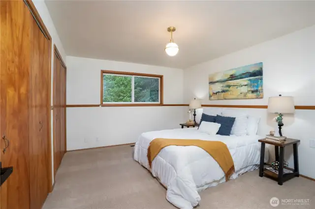 Primary bedroom with dual closets, located next to main bathroom.