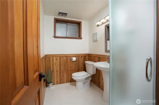 Refreshed lower level 3/4 bathroom with radius shower & new fixtures.