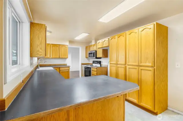 Another view of the kitchen.  Check out the massive pantry cupboards!  There's an outlet in one of them.